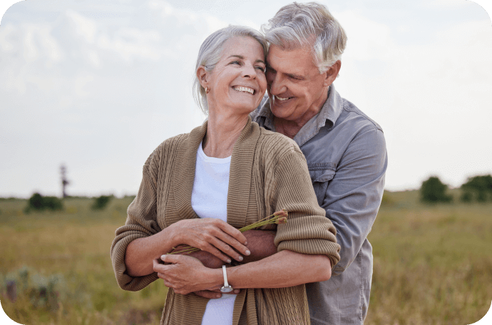 Photo of an elderly couple hugging and smiling