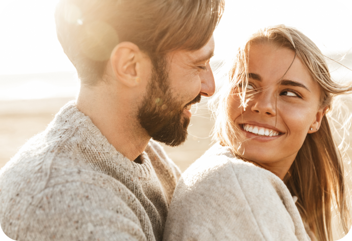 Image of a man and a girl hugging and smiling