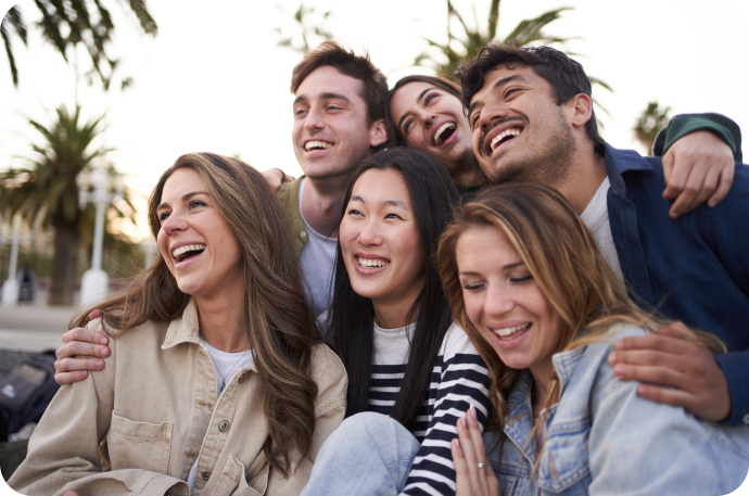 Image of a group of young people smiling and hugging