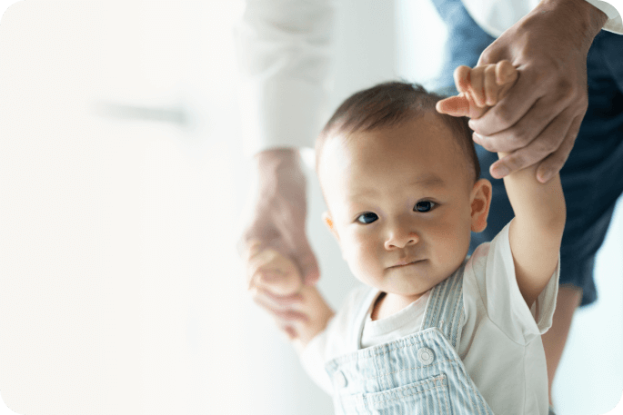 The photo of a young boy learning to walk