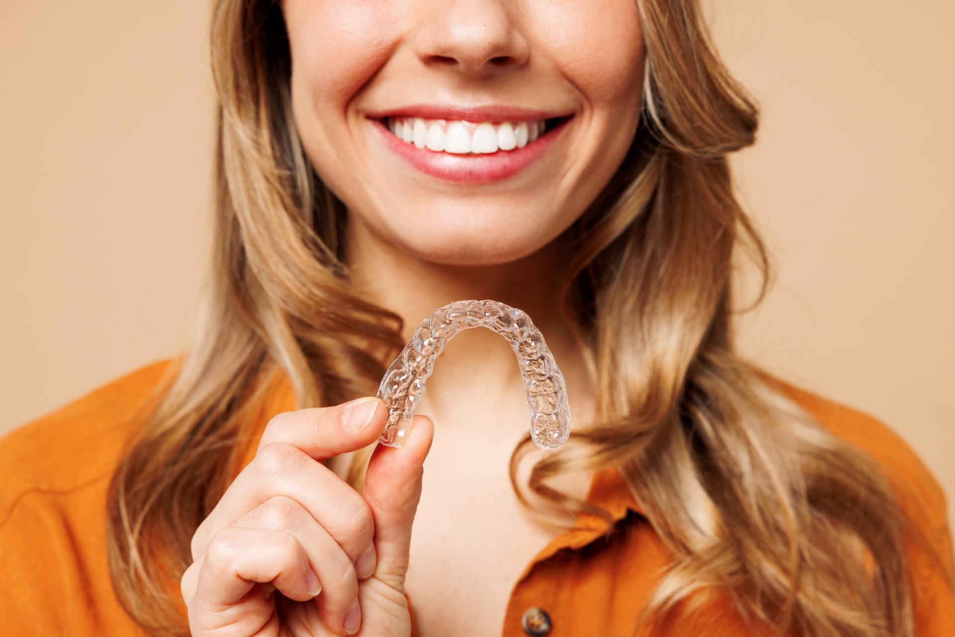 Align your smile discreetly with the transparent metal braces A middle aged woman smiling with transparent braces